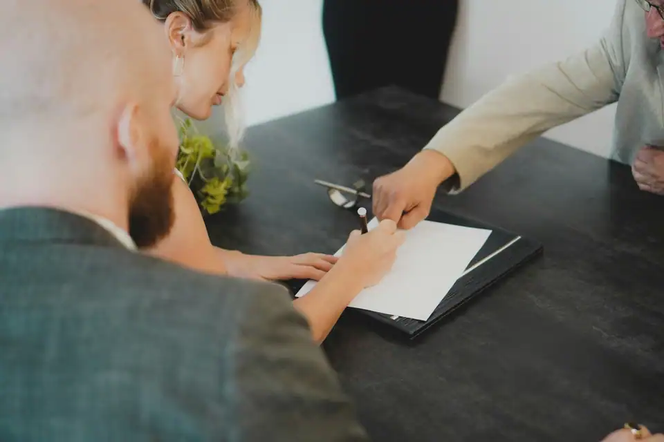 Two people going through papers at a desk